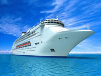 A large cruise ship in the ocean with blue skies.