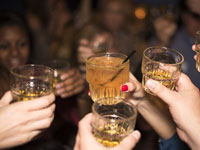 A group of people holding up glasses with drinks.