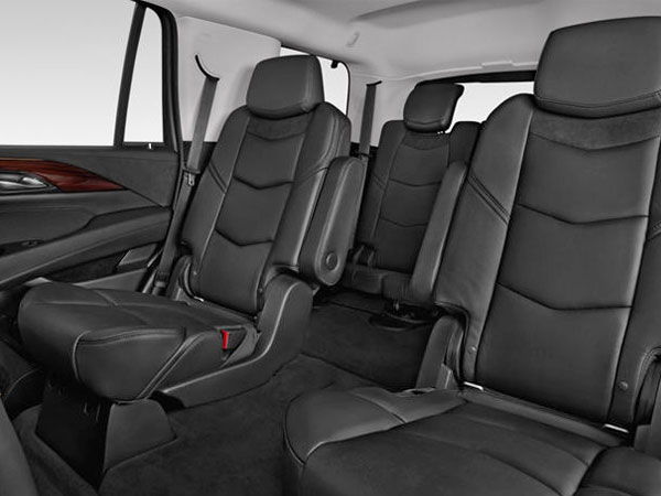 A black leather car seat with the seats folded down.