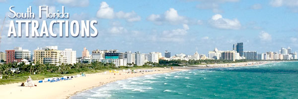 A beach with many people on it and buildings in the background